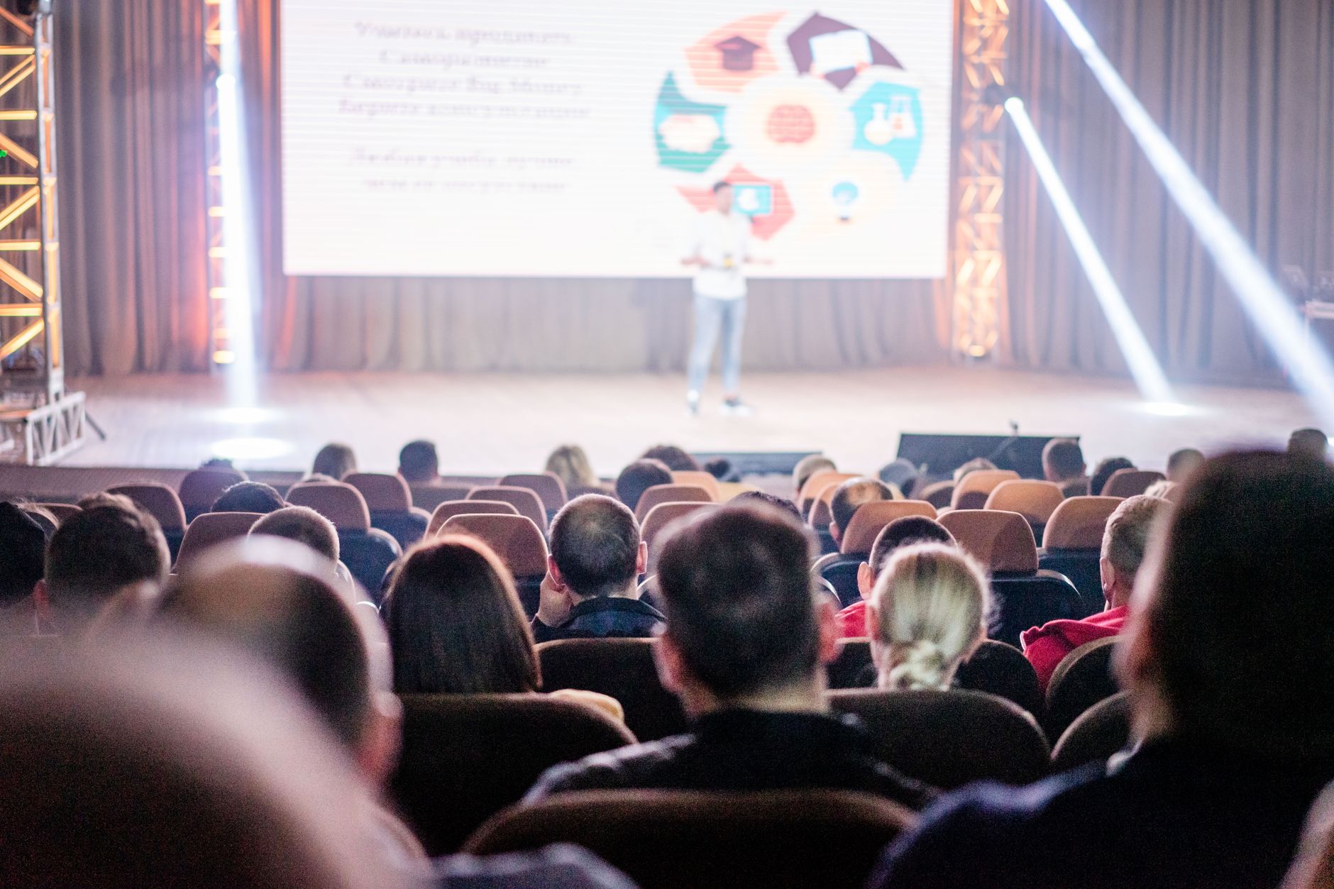 Speaker presenting to a seated audience at a technology conference